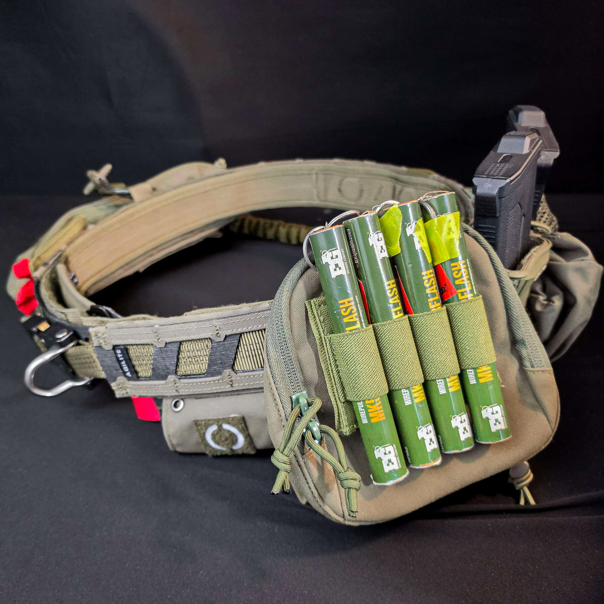 Green BFly 4-round holder with four MK5 thunderflash grenades mounted on a belt pouch (grenades not included)