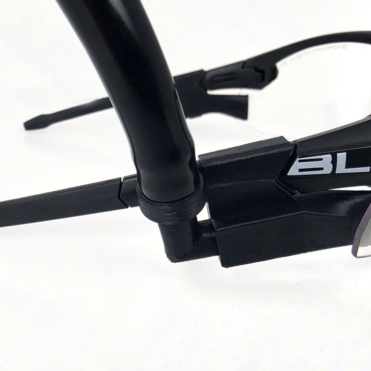 Close-up of magnetic 90 degree insert connected to N-Bore tubing on tactical glasses